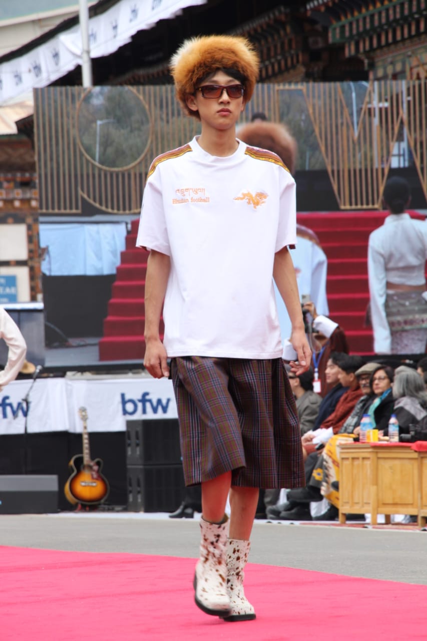 These shorts are made from used gho fabrics, reworked into a modern, silhouette. Each pair retains the original gho lining - while a strip of kira detailing runs along the side, blending masculine and feminine craftsmanship. The design highlights how heritage and reuse can coexist through thoughtful reconstruction.